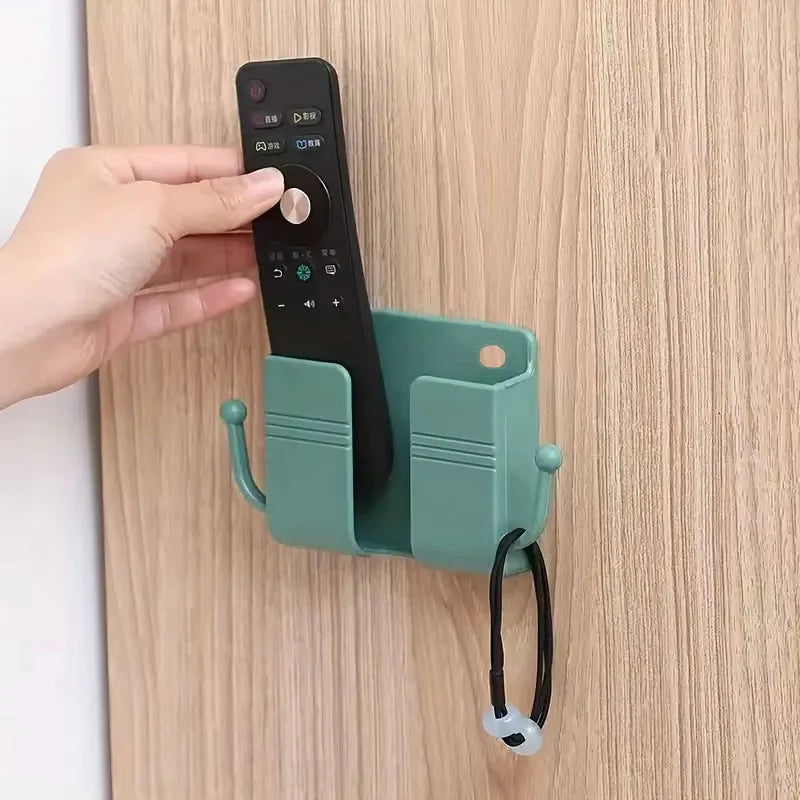 ¡Dile adiós al desorden con el innovador Soporte Adhesivo para Teléfono con Ganchos y Caja de Almacenamiento! Este práctico y funcional accesorio es la solución ideal para mantener tu teléfono móvil y controles remotos organizados